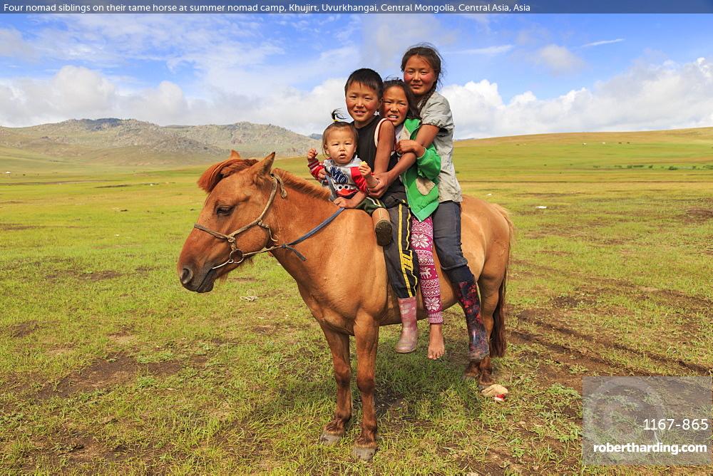 Four nomad siblings on their tame horse at summer nomad camp, Khujirt, Uvurkhangai, Central Mongolia, Central Asia, Asia
