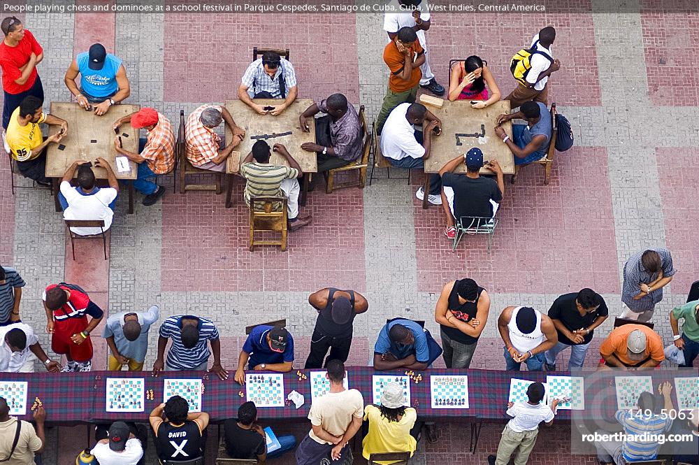People playing chess and dominoes at a school festival in Parque Cespedes, Santiago de Cuba, Cuba, West Indies, Central America