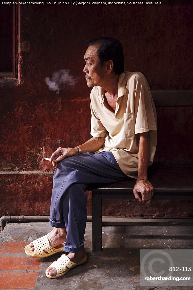 Temple worker smoking, Ho Chi