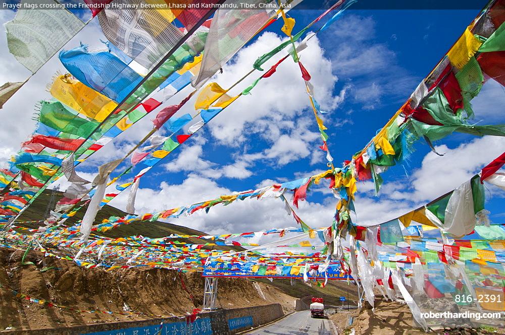 Prayer flags crossing the Friendship Highway between Lhasa and Kathmandu, Tibet, China, Asia
